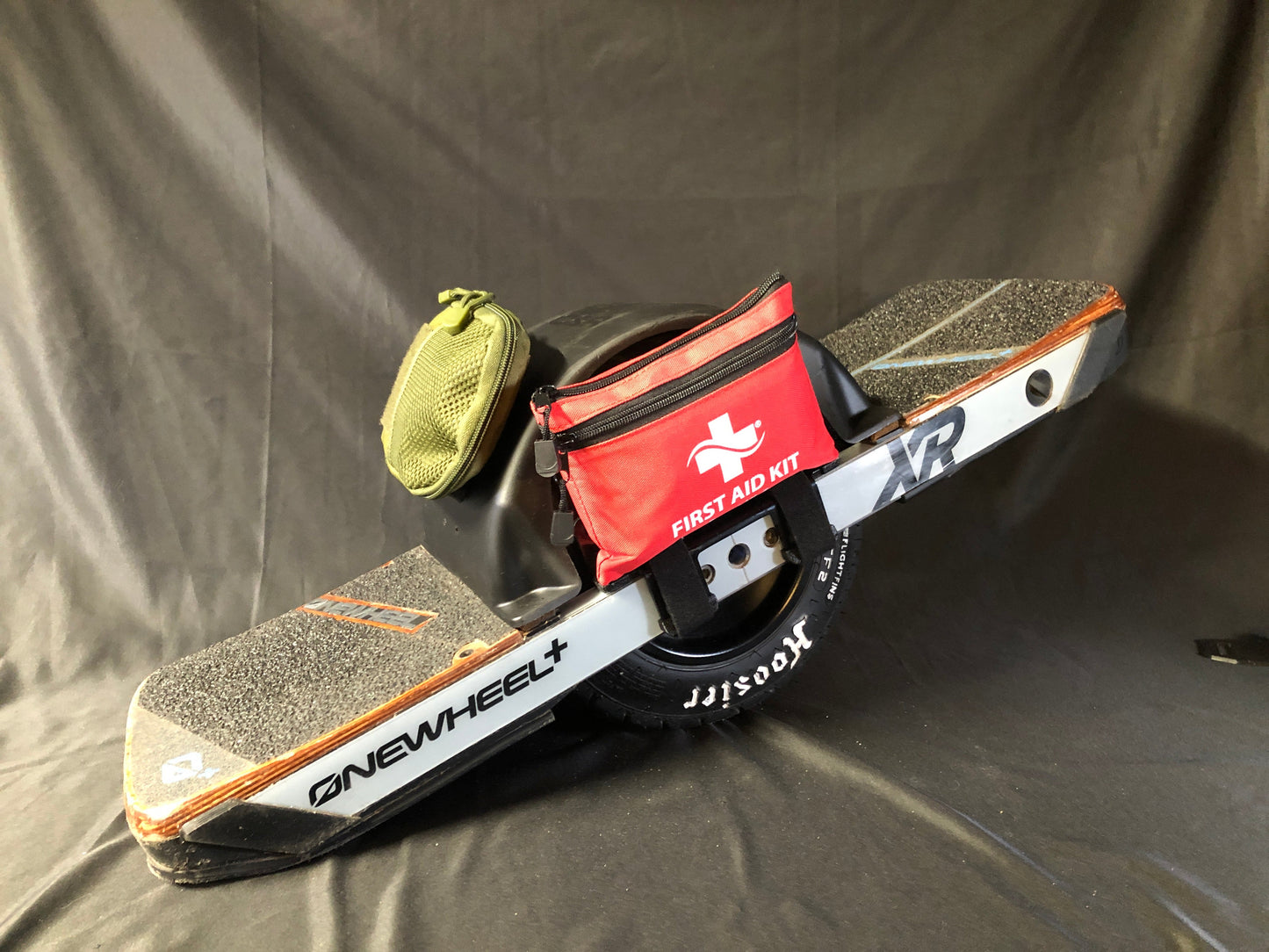 Onewheel XR with first aid kit mounted on side an another small bag on fender